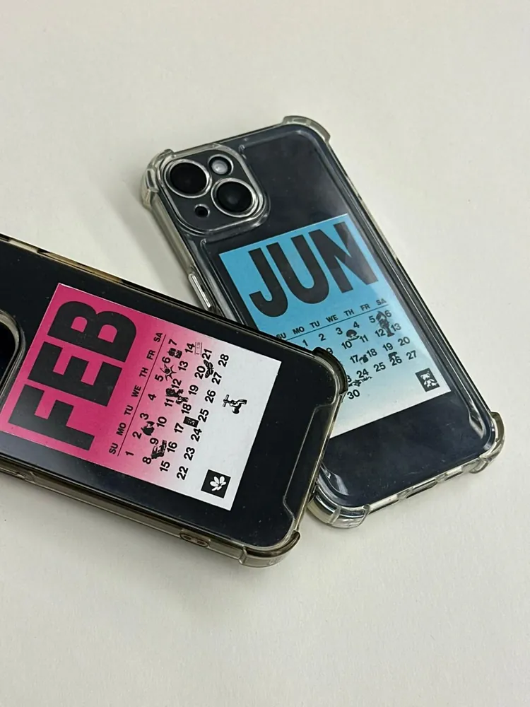 Two phones with FEB and JUN pages slipped inside transparent cases