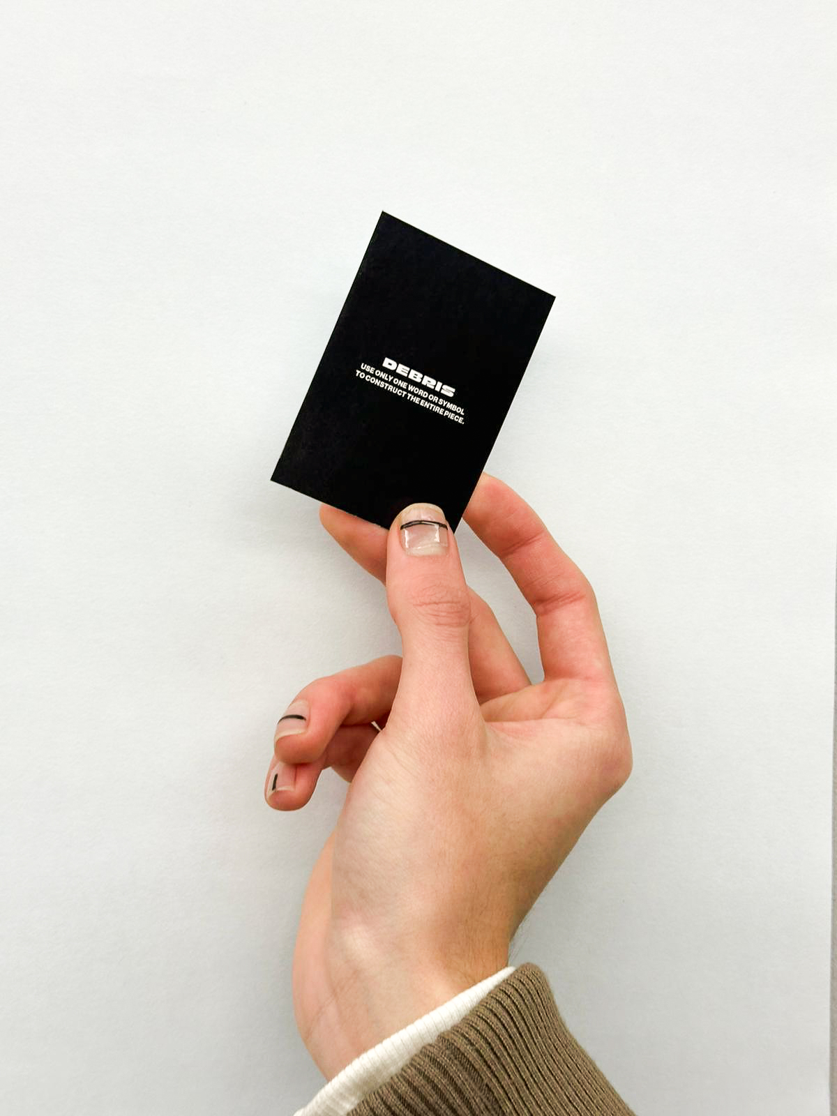 A hand holding the black back cover of the calendar