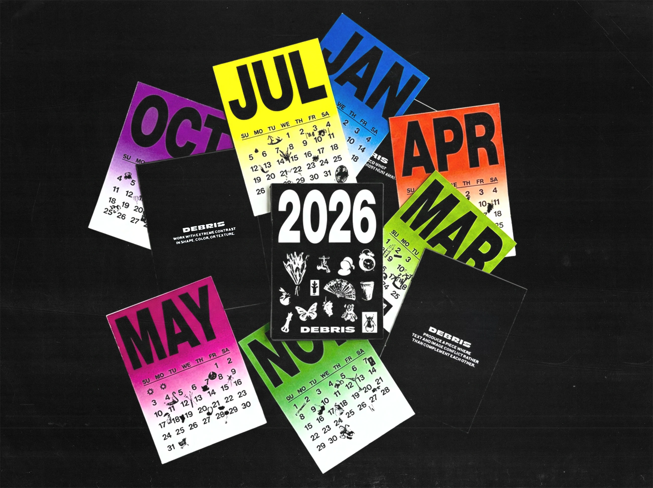 The twelve months scattered loose on a dark surface, each in a different colour