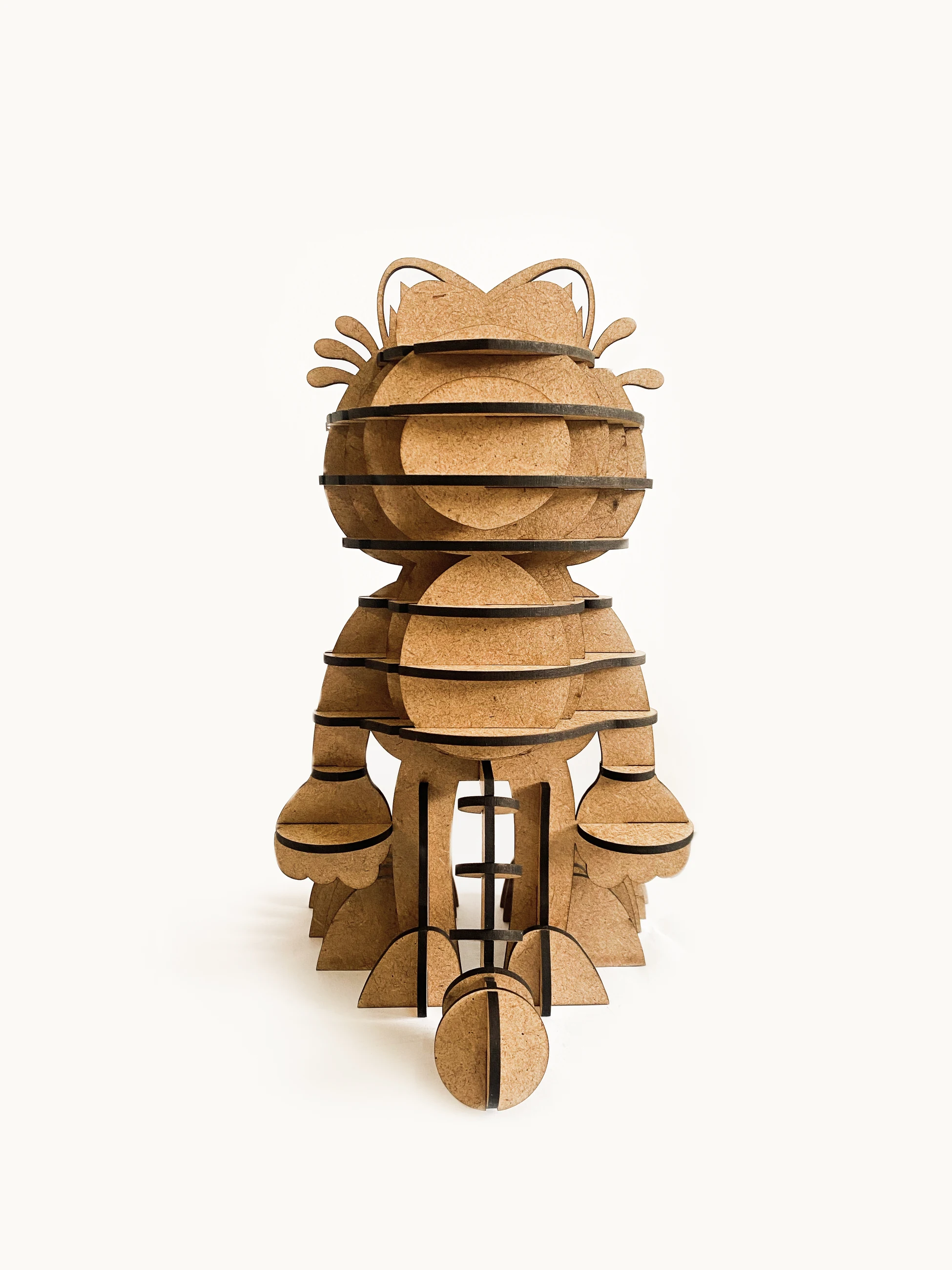 The figure seen from behind, the head a blank stack of discs