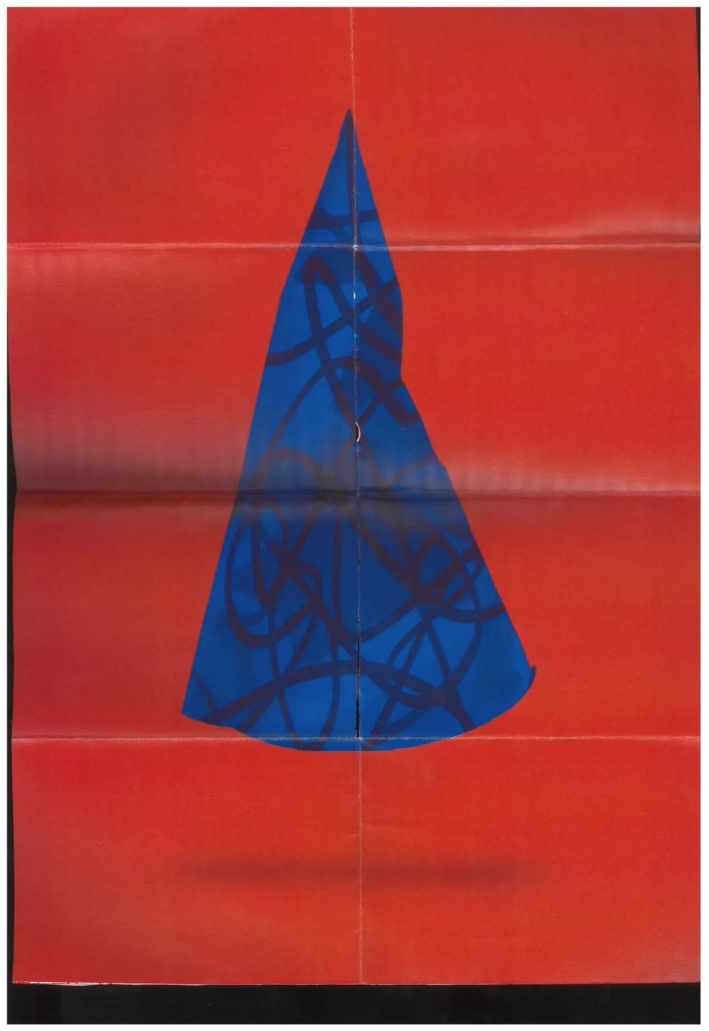 The reverse of the poster: a crumpled blue party hat on red